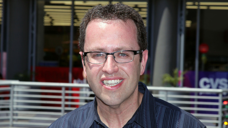 Jared Fogle smiling in glasses and blue shirt