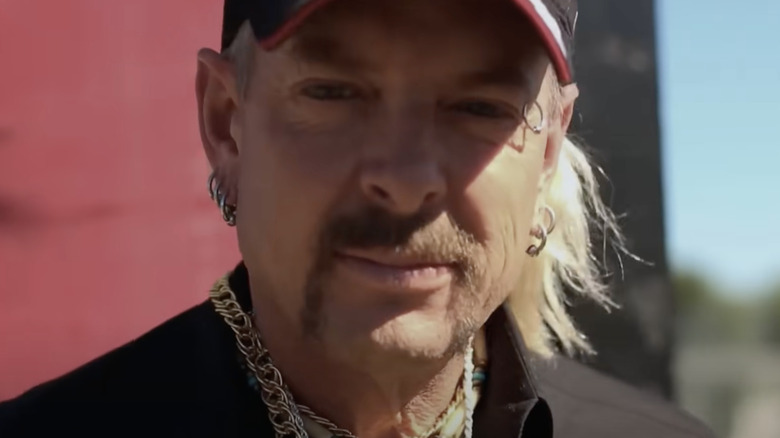 Joe Exotic staring into camera wearing baseball cap