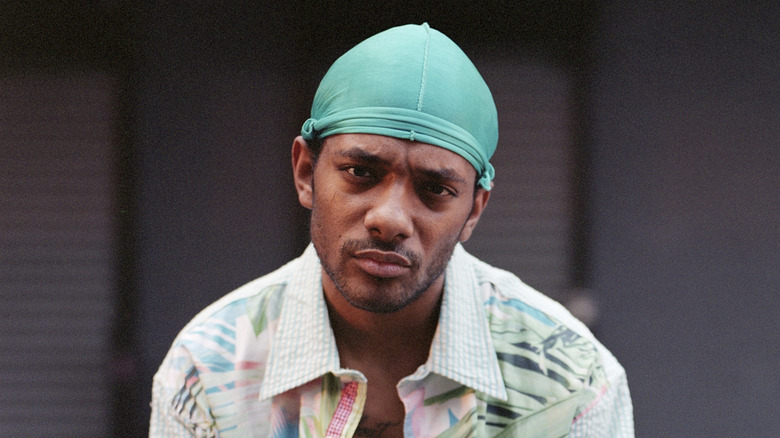 Rapper Prodigy wearing turquoise durag looking serious