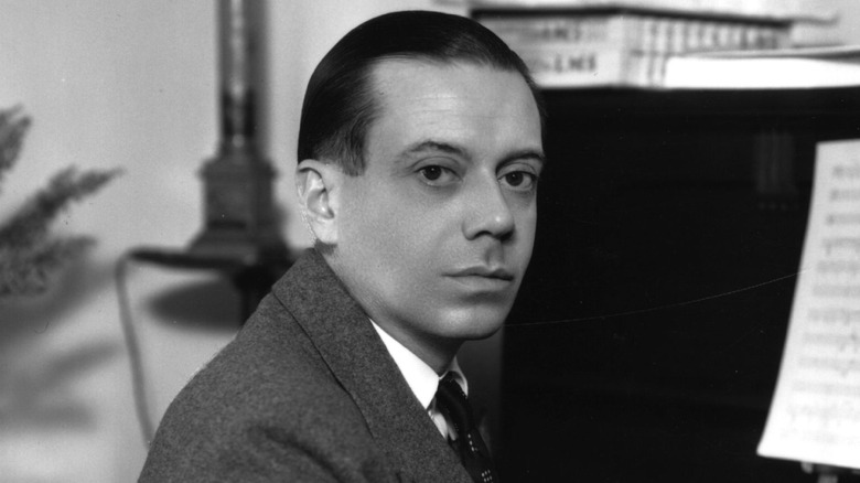 Cole Porter sitting at piano