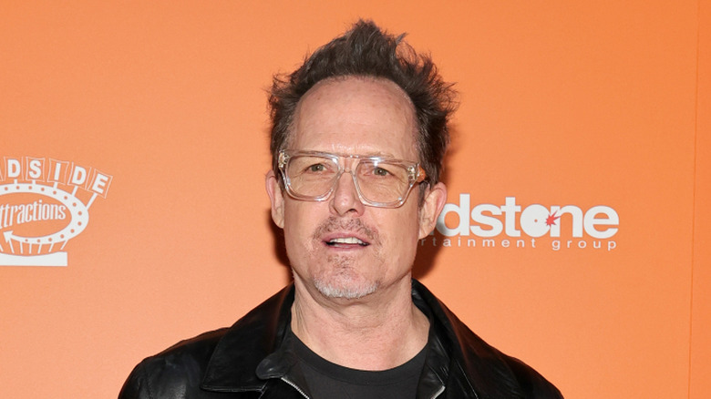 Dean Winters in glasses looking off