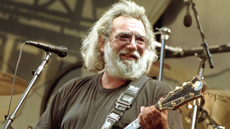 Jerry Garcia playing guitar on stage
