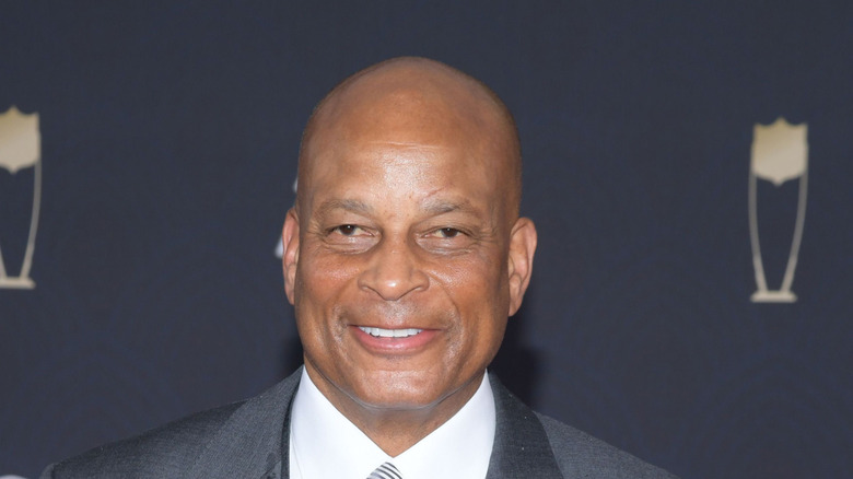 Ronnie Lott smiling and looking away