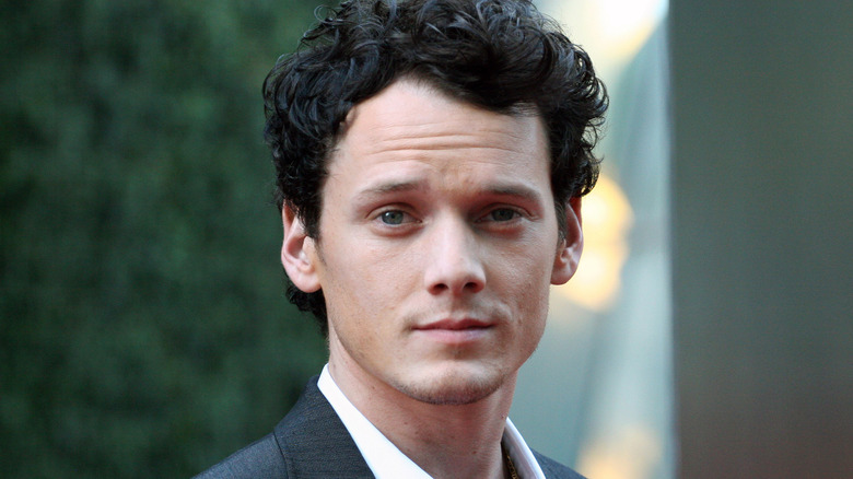 Anton Yelchin smirking at camera