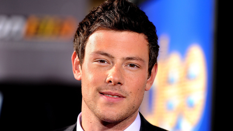 Cory Monteith smiling in suit at event