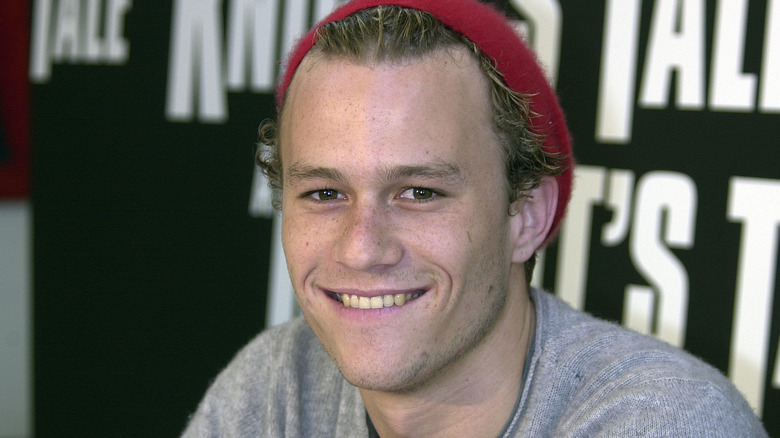 Heath Ledger in red hat smiling