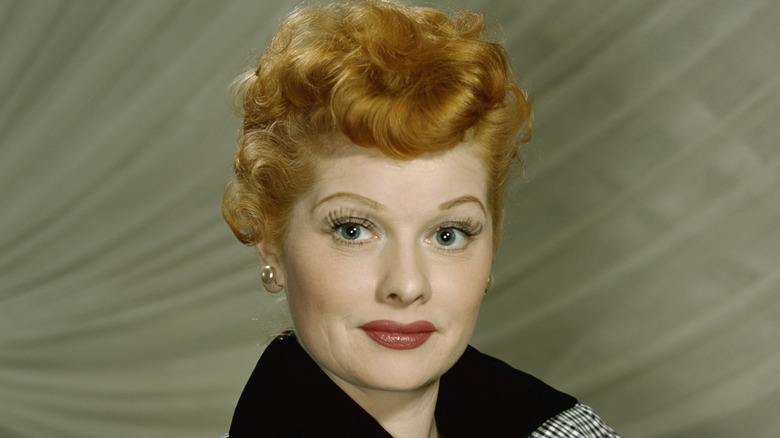Lucille ball in monochrome checkered jacket with red hair in neutral pose