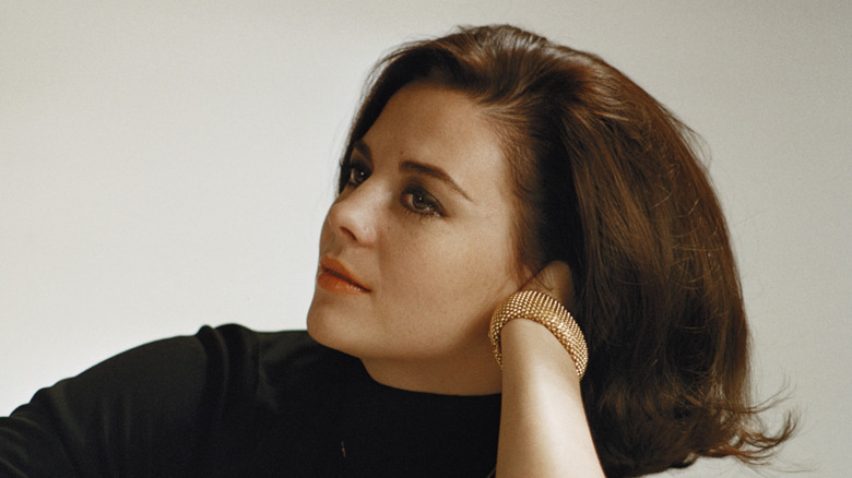 Natalie Wood in black top with head on hand
