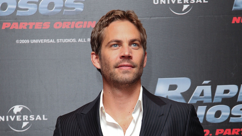 Paul Walker staring up in suit at event