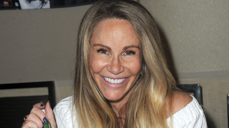 Tawny Kitaen in white top smiling