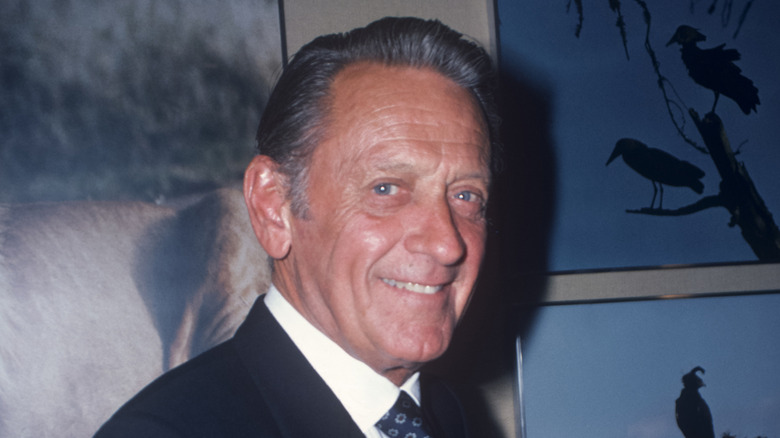 William Holden older and looking at camera apprehensively