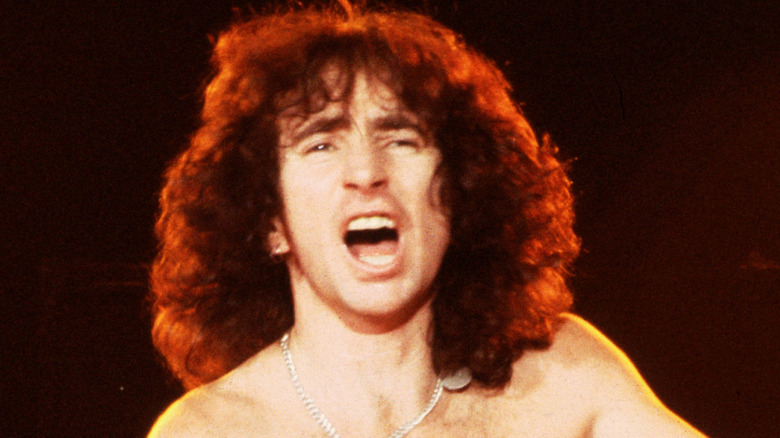 Bon Scott yelling shirtless on stage