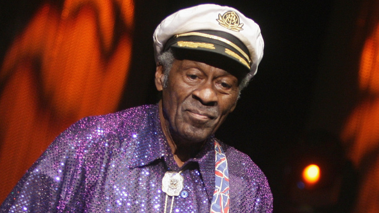 Chuck Berry wearing captain's hat and playing guitar