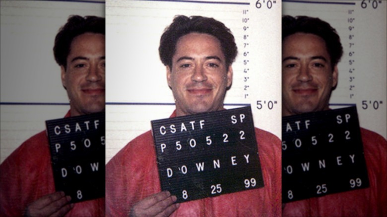 Robert Downey Jr. smiling in mugshot
