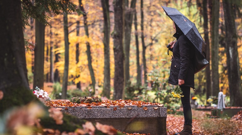 Standing at a grave