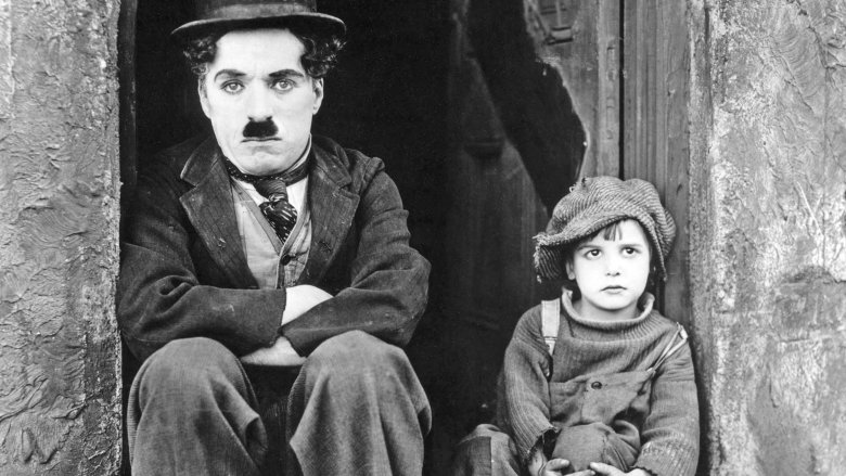 charlie chaplin sitting in doorway