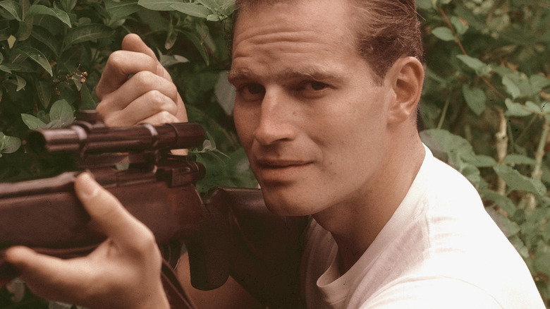 Charlton Heston with rifle