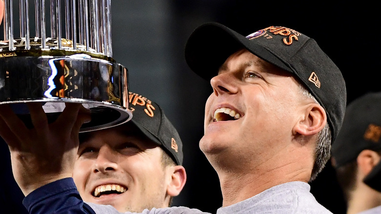 Astros coach A.J. Hinch holds trophy