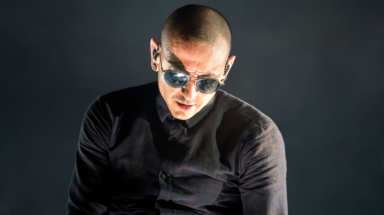 Chester Bennington wearing sunglasses while performing