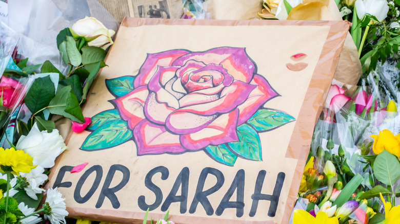 Sarah Everard memorial sign with flowers