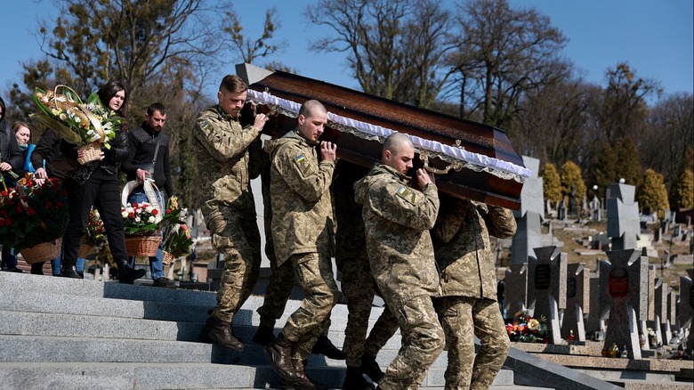 Ukrainian soldiers carrying casket