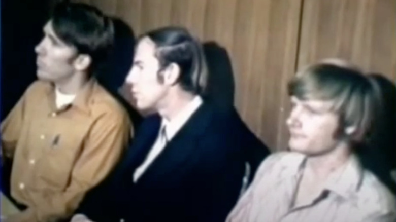 The three perpetrators waiting to enter the courtroom