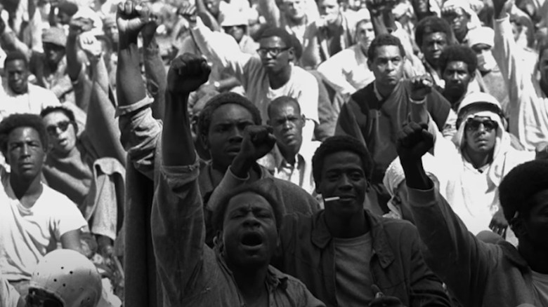 Inmates at Attica with fists in air