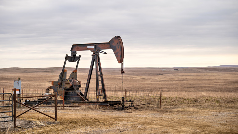 lone pumpjack working on oklahoma prairie