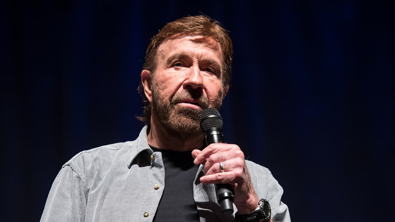 Chuck Norris speaking on stage in 2017