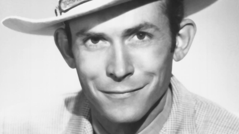 Hank Williams smiling in a cowboy hat