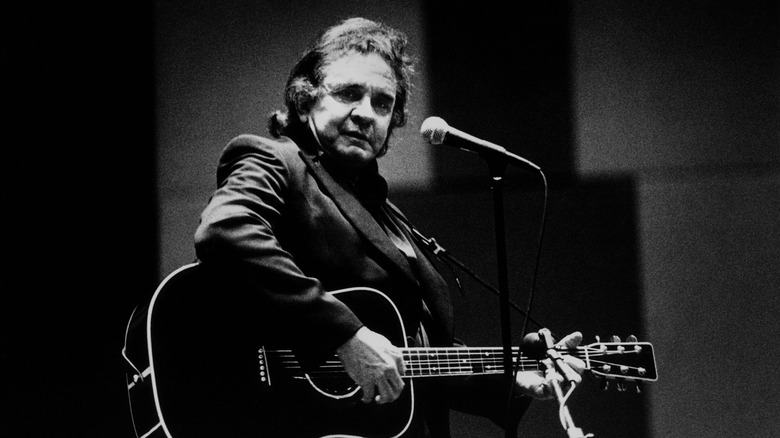 Johnny Cash playing acoustic guitar