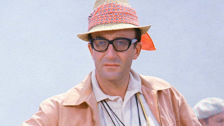Peter Sellers in pink jacket, hat, and glasses