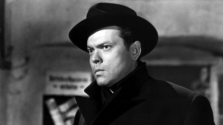 Orson Welles in black jacket and hat