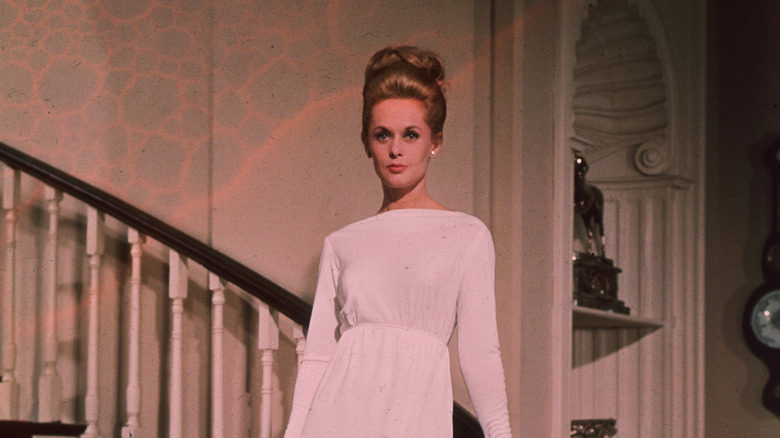 Tippi Hedren stood on staircase in pink dress