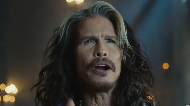 Aerosmith's Steven Tyler singing into a microphone on stage