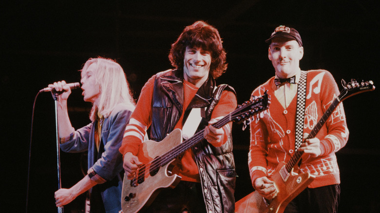 Cheap Trick smiling and performing onstage in Japan