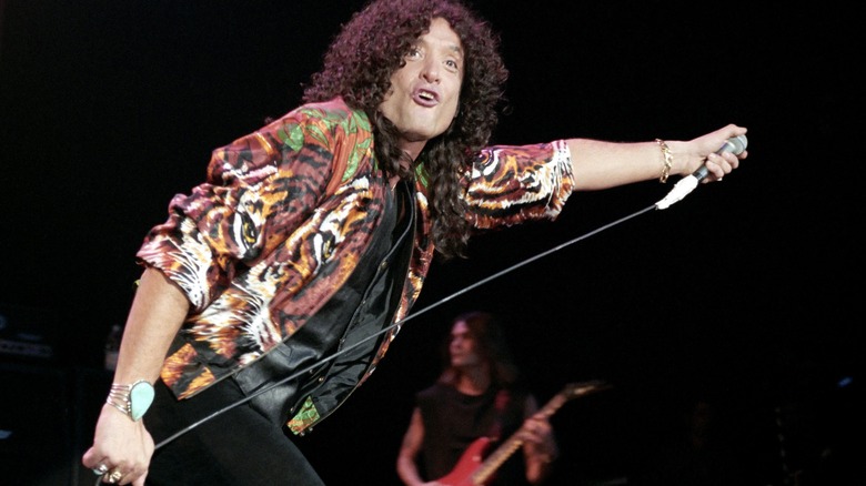 Quiet Riot's Kevin Dubrow performing onstage mic stretching