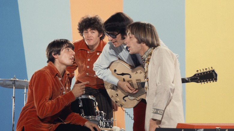 The Monkees singing together on stage