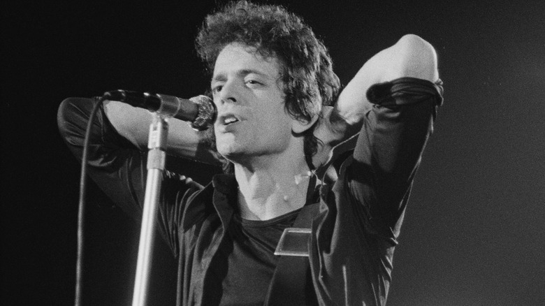 Lou Reed onstage hands behind head
