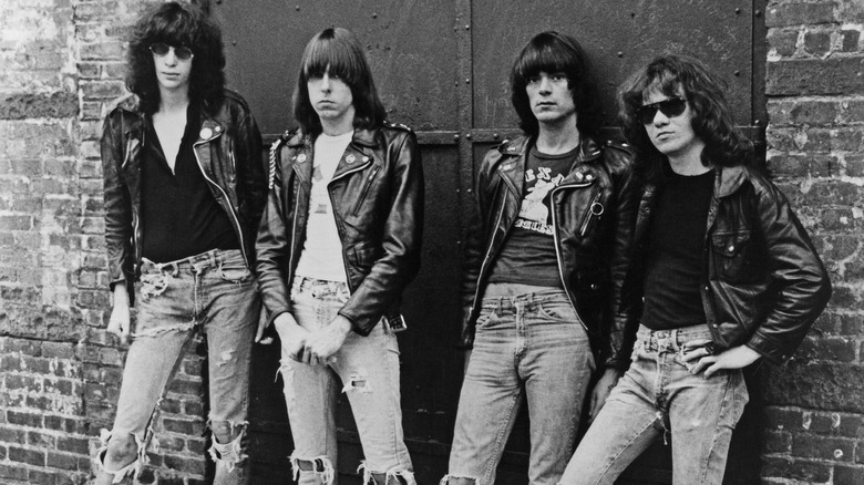 The Ramones standing brick wall jeans leather jackets