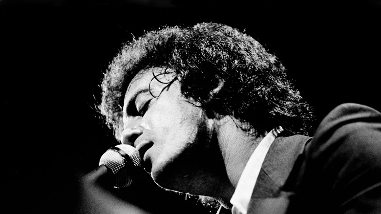 Billy Joel singing into microphone