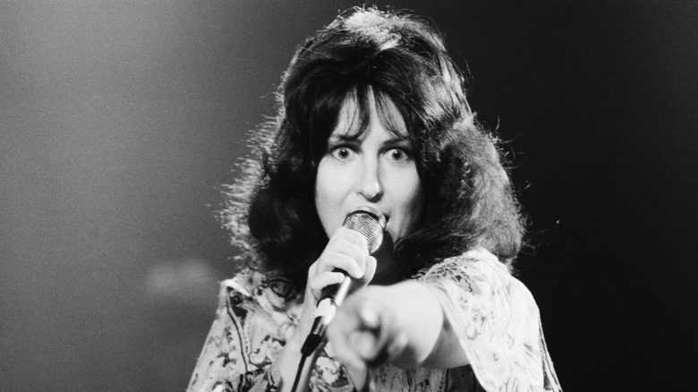 Grace Slick wide-eyed and pointing at audience