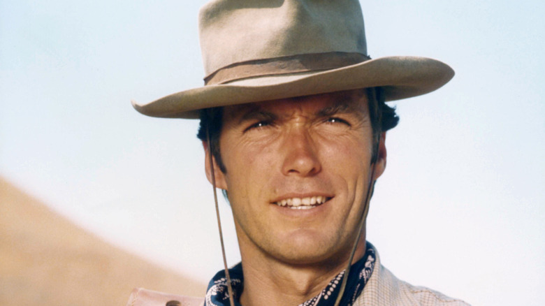 Clint Eastwood smiles under cowboy hat