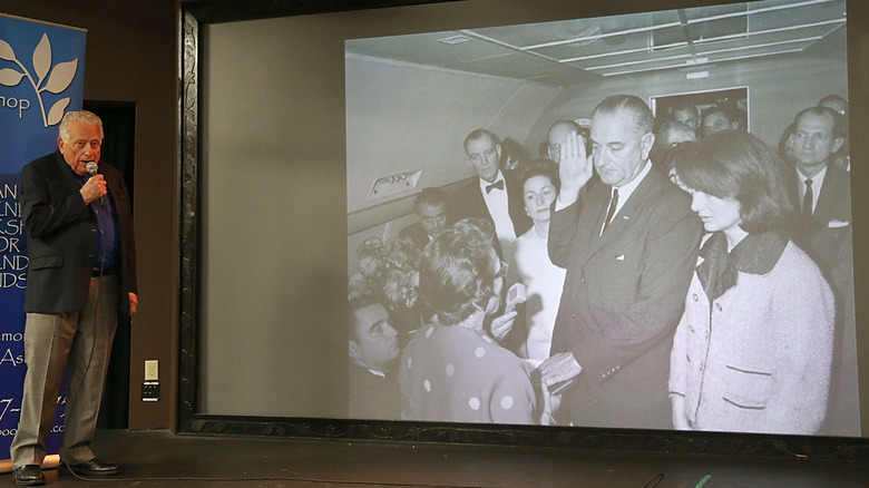 Clint Hill speaking LBJ sworn in photo on projector