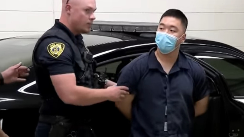 Ji Min Sha being transported to court