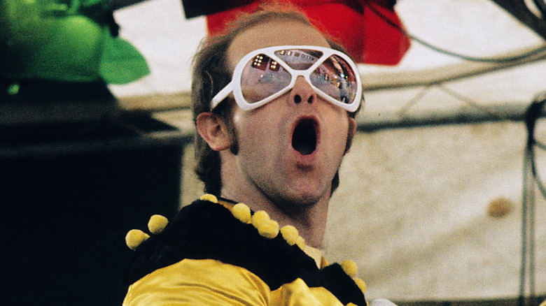 Elton John singing onstage in the 1970s