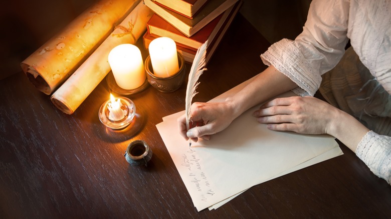 A quill pen by candlelight