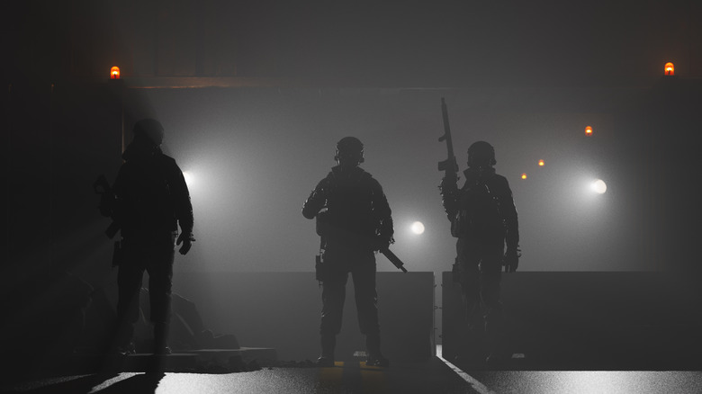 Soldiers barricading night road