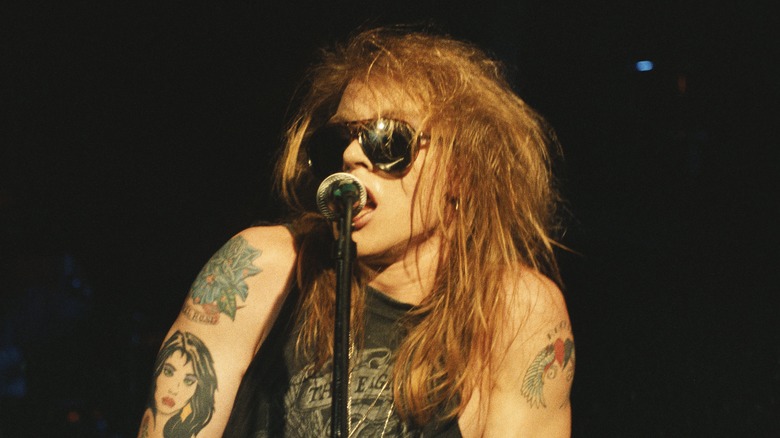 Axl Rose performing in sunglasses