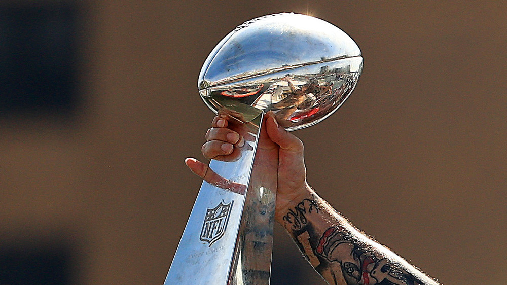 arm holding out Super Bowl trophy